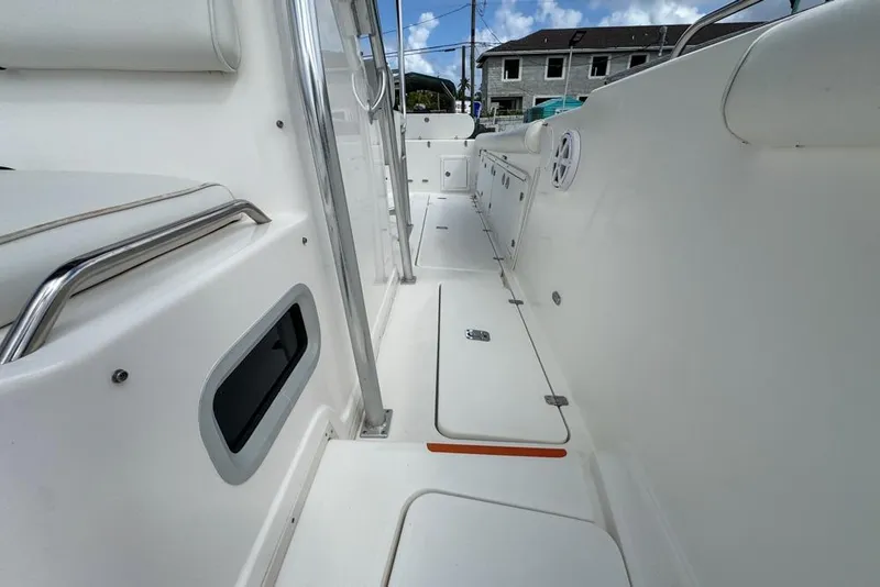 Slide: The Image of 2000 Century 3200 Center Console boat interior with white seating and storage compartments. - 106