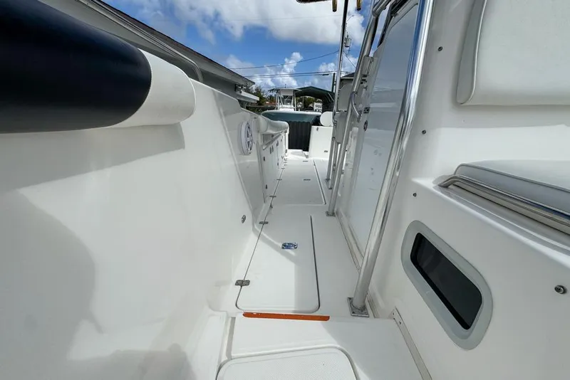 Slide: The Image of 2000 Century 3200 Center Console boat deck, featuring sleek white design and modern fittings. - 107