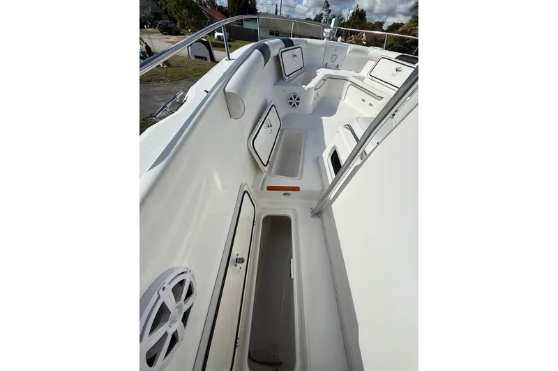 Slide: The Image of 2000 Century 3200 Center Console boat on trailer beside house. - 11