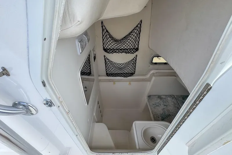Slide: The Image of Interior cabin of 2000 Century 3200 Center Console boat with storage nets and sink. - 112