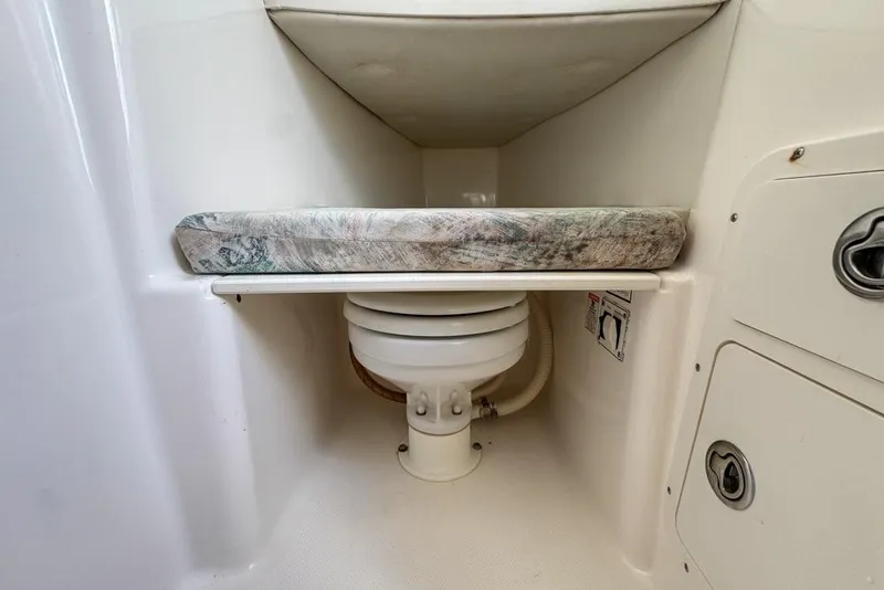 Slide: The Image of 2000 Century 3200 Center Console boat interior with compact marine toilet. - 114