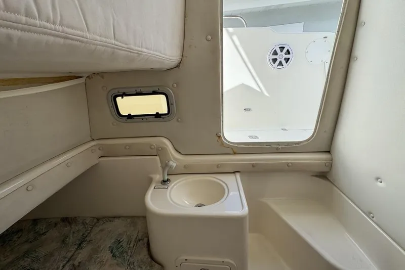 Slide: The Image of Interior of a 2000 Century 3200 Center Console boat with sink and window. - 116