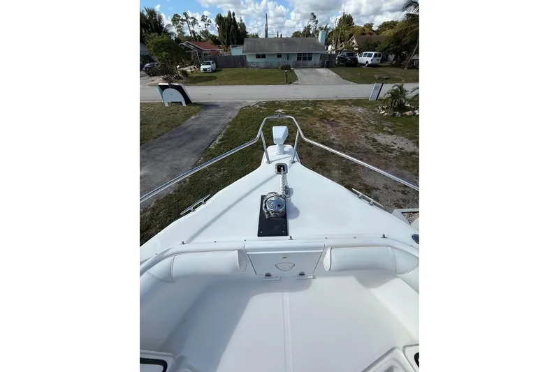 Slide: The Image of 2000 Century 3200 Center Console boat parked between houses, aerial view. - 12