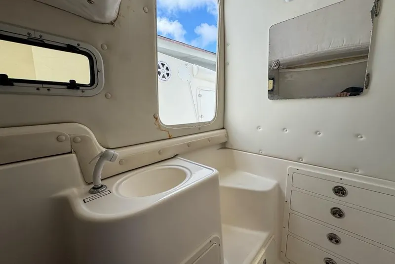 Slide: The Image of Interior of a 2000 Century 3200 Center Console boat with sink and storage. - 121