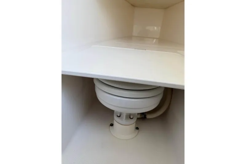 Slide: The Image of 2000 Century 3200 Center Console boat on trailer, parked outdoors under a blue sky. - 16