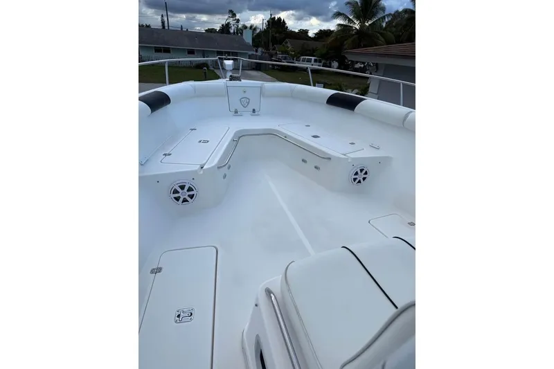 Slide: The Image of 2000 Century 3200 Center Console boat on trailer between two houses. - 18