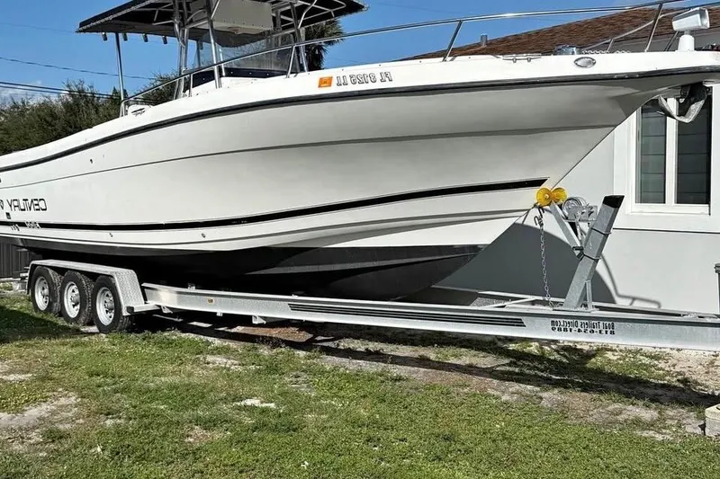Slide: The Image of Century 3200 Center Console boat, 2000 model, on a trailer under a blue sky. - 2