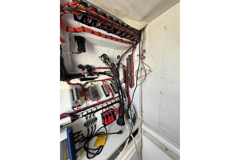 Slide: The Image of 2000 Century 3200 Center Console boat on trailer between buildings, under clear blue sky. - 20