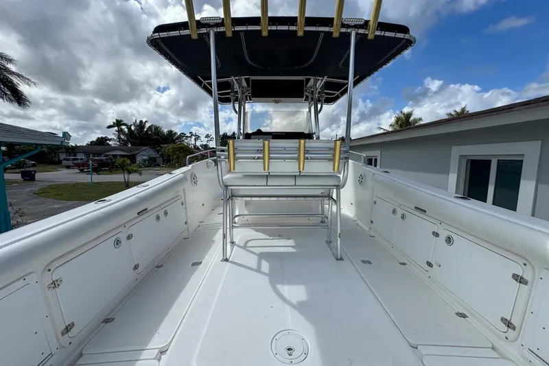 Slide: The Image of Century 3200 Center Console boat, 2000 model, with spacious deck and seating under a cloudy sky. - 22