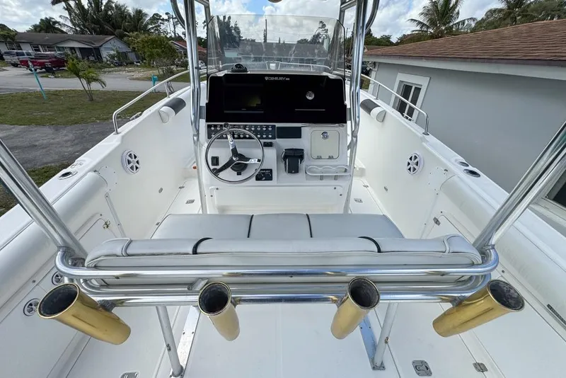 Slide: The Image of Century 3200 Center Console boat, 2000 model, featuring a sleek helm and rod holders. - 25