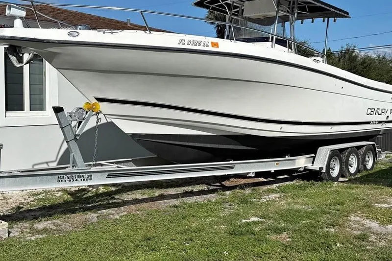 Slide: The Image of Century 3200 Center Console boat, 2000 model, with Mercury Verado engine on trailer. - 3