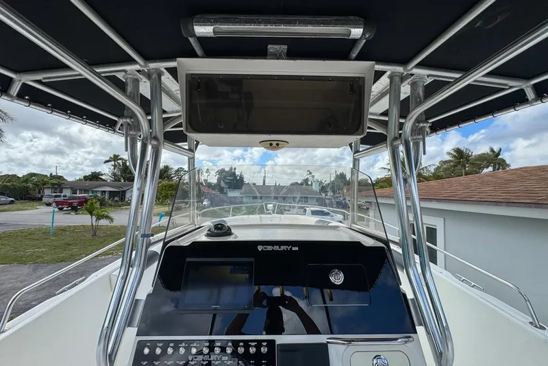 Slide: The Image of Century 3200 Center Console 2000 boat interior with navigation equipment and overhead storage. - 31
