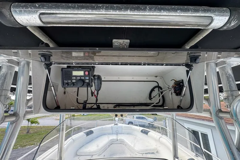 Slide: The Image of 2000 Century 3200 Center Console boat with open electronics compartment and visible wiring. - 36