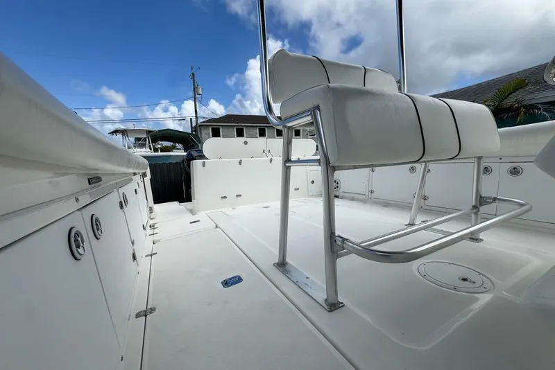 Slide: The Image of 2000 Century 3200 Center Console boat interior with white seating and storage compartments. - 39