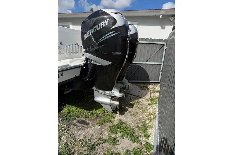 Slide: The Image of Century 3200 Center Console boat, 2000 model, on a trailer with Mercury engines. - 4