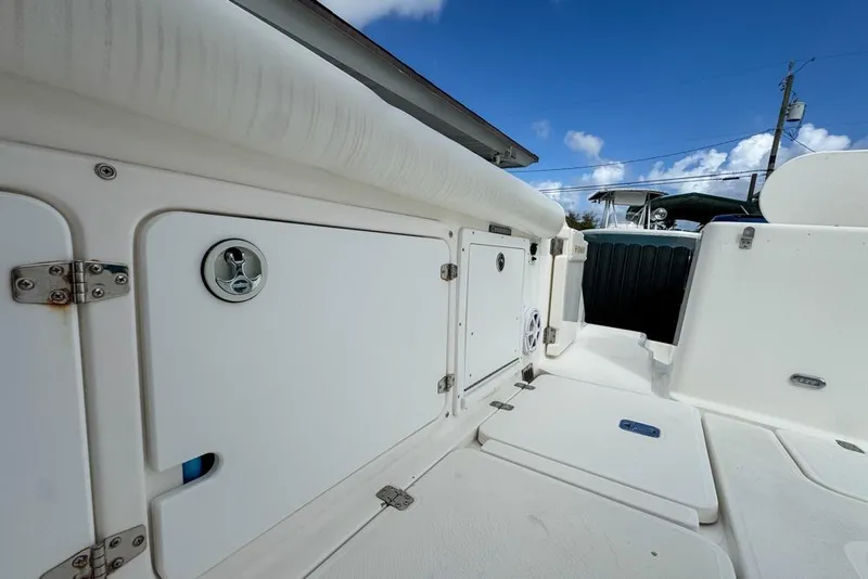 Slide: The Image of 2000 Century 3200 Center Console boat interior with storage compartments under a clear blue sky. - 41