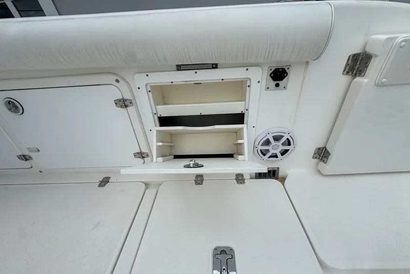 Slide: The Image of Century 3200 Center Console 2000 boat interior with storage compartments and speaker. - 43