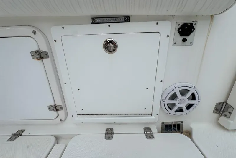 Slide: The Image of Century 3200 Center Console 2000 boat storage compartment with speaker and control panel. - 44