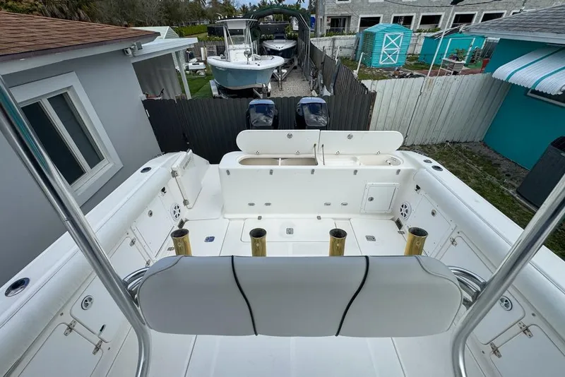 Slide: The Image of 2000 Century 3200 Center Console boat interior with rod holders and seating. - 46