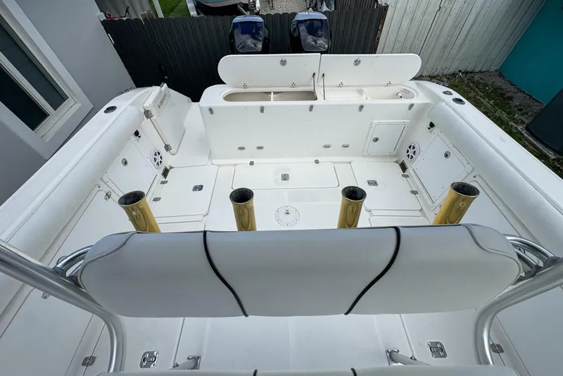 Slide: The Image of 2000 Century 3200 Center Console boat interior with rod holders and storage compartments. - 47
