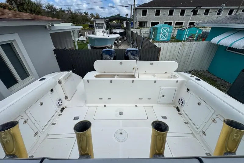 Slide: The Image of 2000 Century 3200 Center Console boat interior with storage compartments and rod holders. - 48