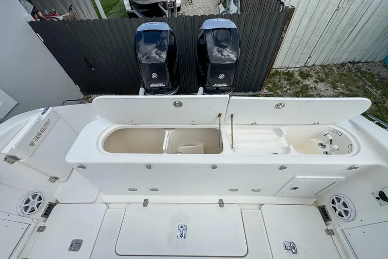 Slide: The Image of Century 3200 Center Console 2000 model with open storage compartments and dual outboard motors. - 51