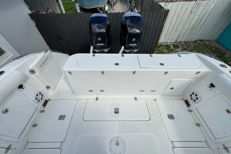 Slide: The Image of 2000 Century 3200 Center Console boat deck with dual outboard motors. - 57