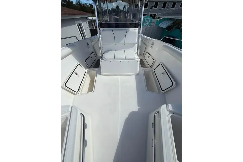 Slide: The Image of 2000 Century 3200 Center Console boat on trailer, parked outdoors. - 6