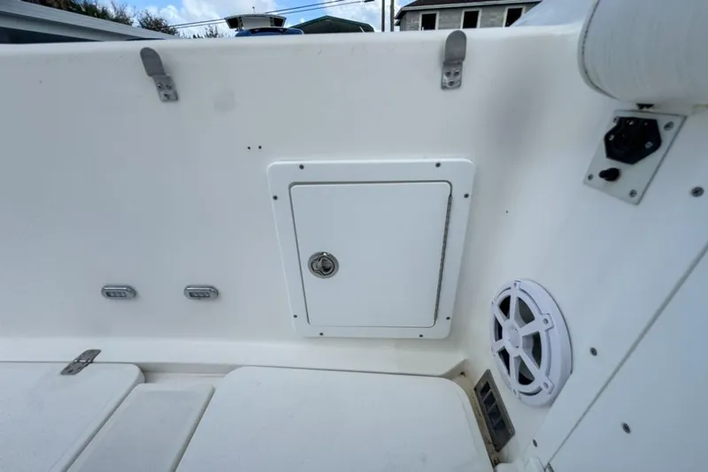 Slide: The Image of 2000 Century 3200 Center Console boat interior with storage compartment and speaker. - 63