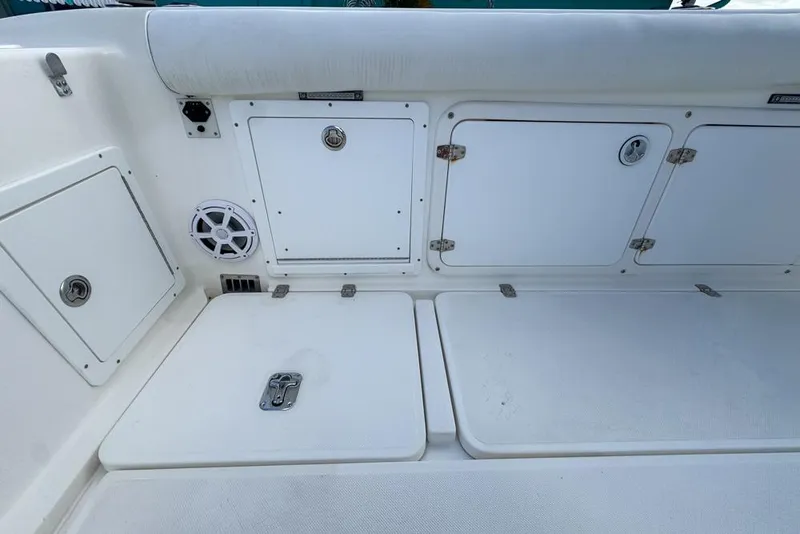 Slide: The Image of 2000 Century 3200 Center Console boat interior with storage compartments and speaker. - 65