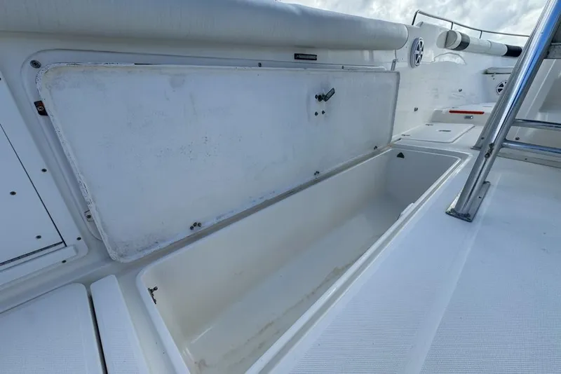 Slide: The Image of Open storage compartment on a 2000 Century 3200 Center Console boat deck. - 69