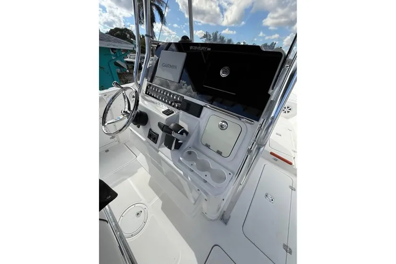 Slide: The Image of 2000 Century 3200 Center Console boat on trailer, parked beside a house. - 7