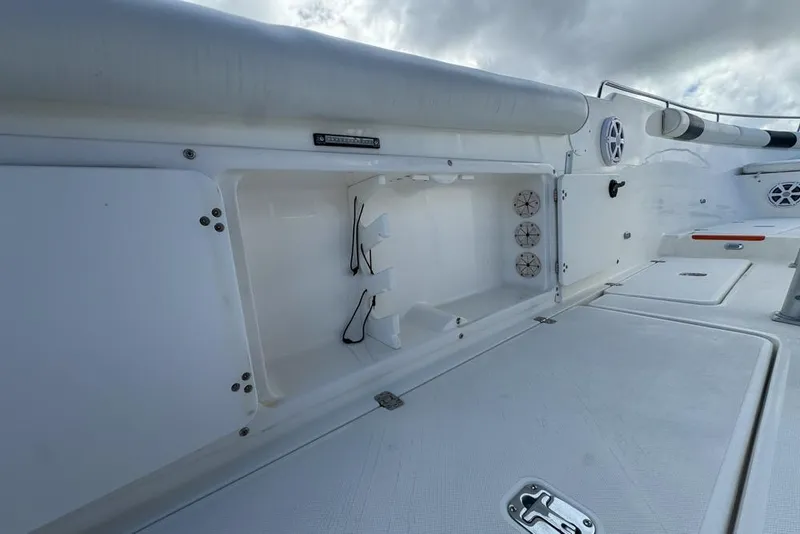 Slide: The Image of 2000 Century 3200 Center Console boat interior with storage compartment and speakers. - 72