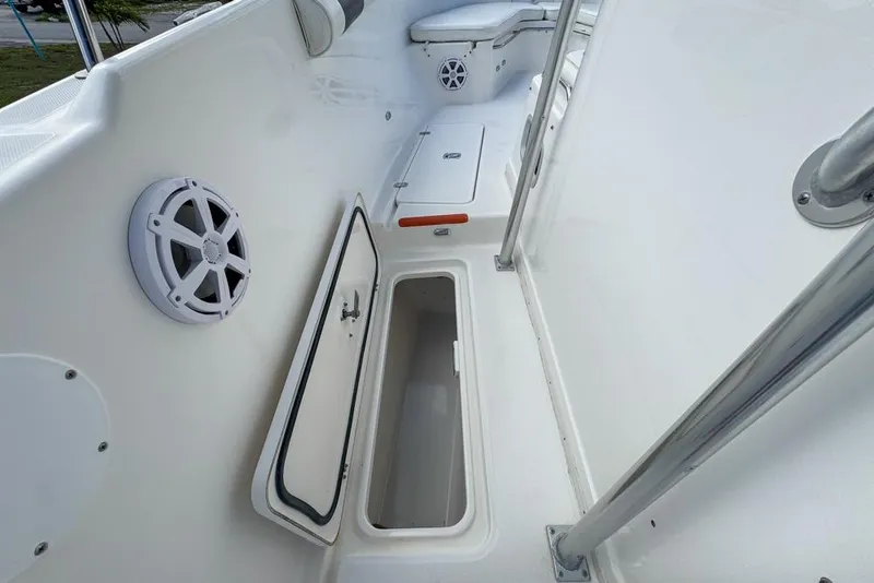 Slide: The Image of 2000 Century 3200 Center Console boat interior with storage compartment and speaker. - 74