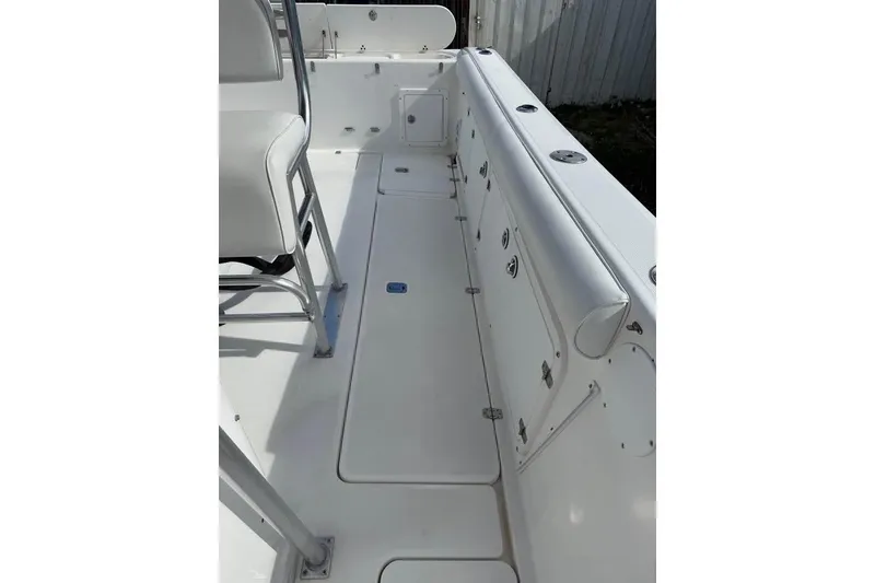 Slide: The Image of 2000 Century 3200 Center Console boat on trailer, parked beside a house. - 8