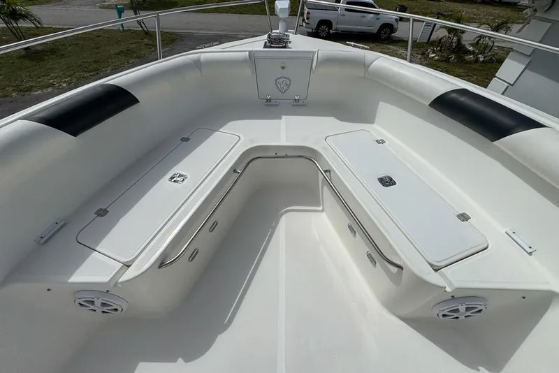 Slide: The Image of Century 3200 Center Console 2000 boat interior with seating and storage compartments. - 80
