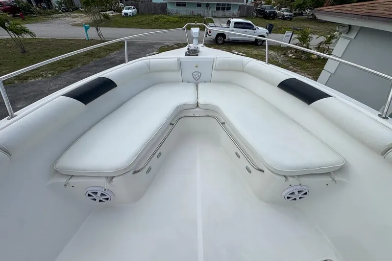 Slide: The Image of 2000 Century 3200 Center Console boat with white cushioned seating and speakers. - 82