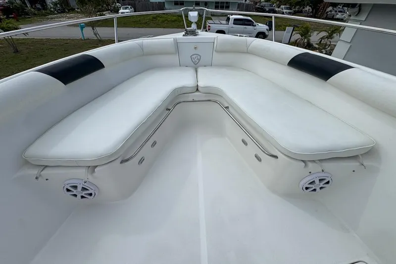 Slide: The Image of Century 3200 Center Console 2000 boat with white cushioned seating and speakers. - 84