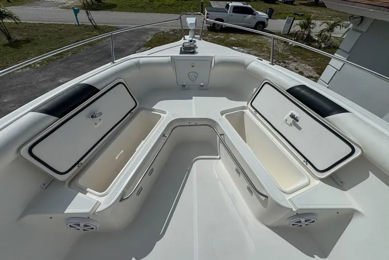 Slide: The Image of 2000 Century 3200 Center Console boat with open storage compartments on deck. - 88