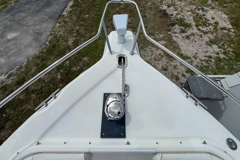 Slide: The Image of Bow view of a 2000 Century 3200 Center Console boat with anchor chain and railing. - 92
