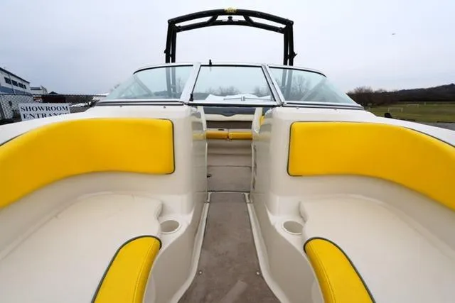 Slide: The Image of 2006 Sea Ray 205 Sport boat interior with yellow seating and open deck view. - 10