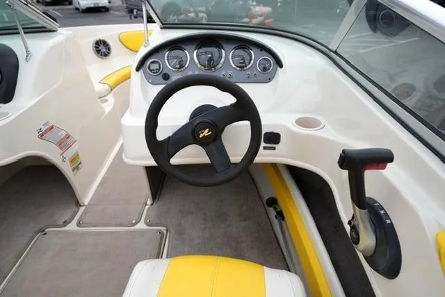 Slide: The Image of 2006 Sea Ray 205 Sport boat interior with steering wheel and dashboard controls. - 12