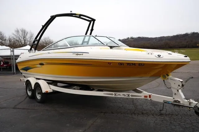 Slide: The Image of 2006 Sea Ray 205 Sport boat on trailer, yellow and white design, parked outdoors. - 3