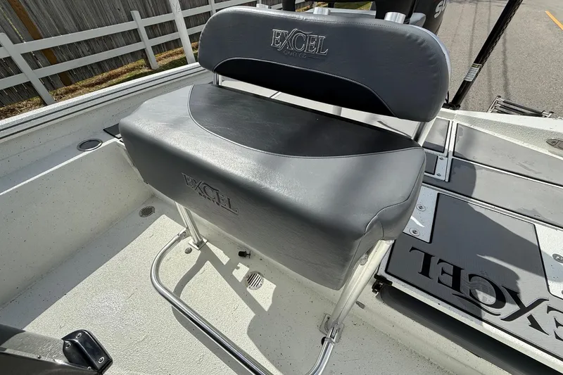 Slide: The Image of 2020 Excel 203 Bay Pro boat interior with cushioned seating and deck details. - 10