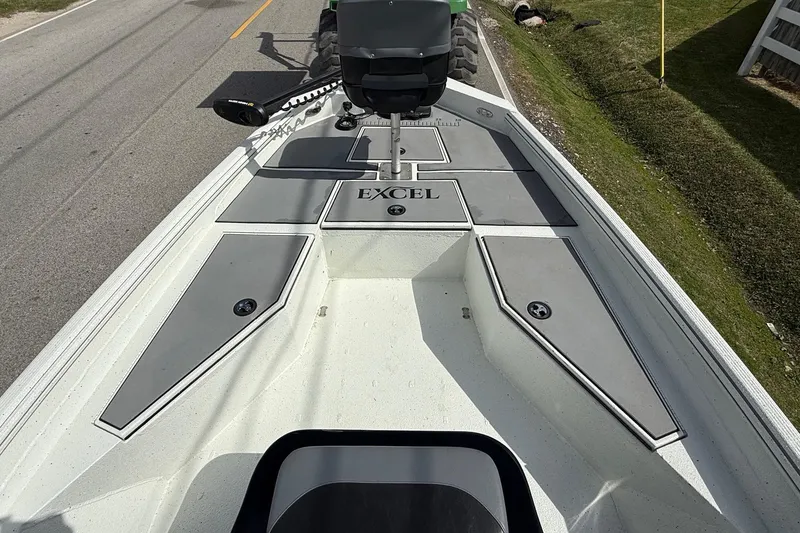 Slide: The Image of 2020 Excel 203 Bay Pro boat deck with storage compartments and seating. - 13