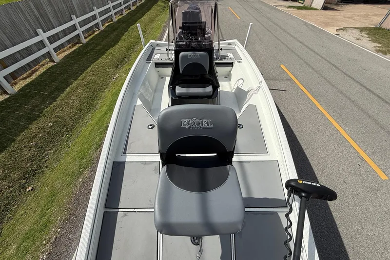 Slide: The Image of 2020 Excel 203 Bay Pro boat on road, featuring seating and trolling motor. - 15