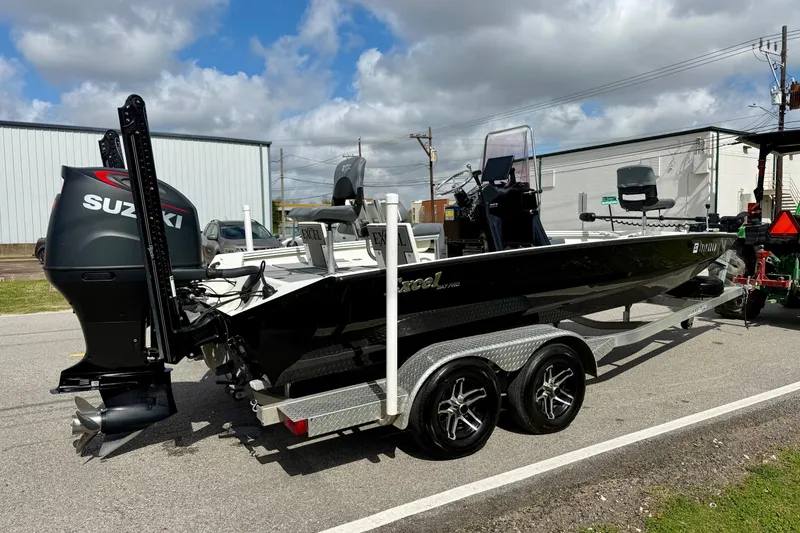 Slide: The Image of 2020 Excel 203 Bay Pro boat with Suzuki engine on trailer, parked outdoors. - 4
