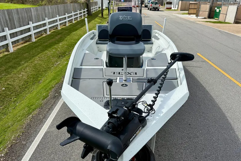 Slide: The Image of 2020 Excel 203 Bay Pro boat with trolling motor on a street. - 6