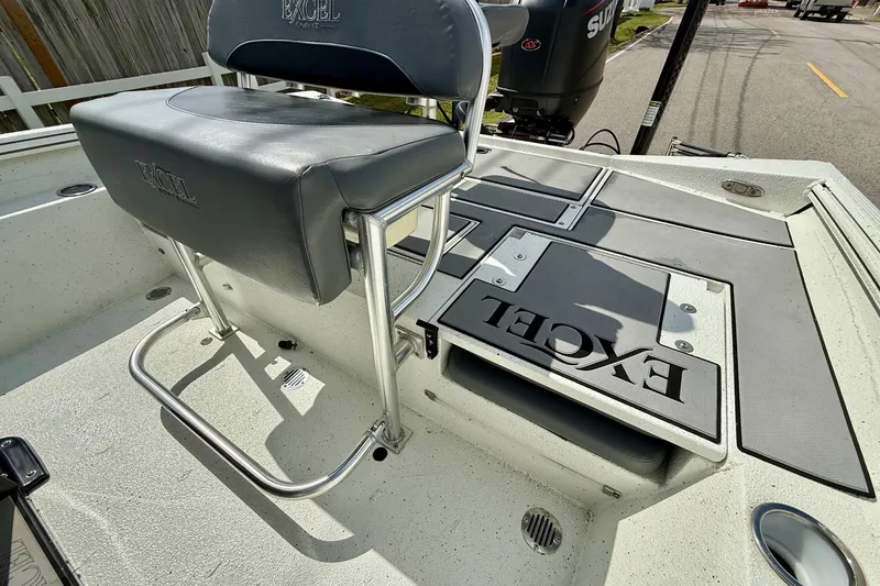Slide: The Image of 2020 Excel 203 Bay Pro boat interior with seating and storage compartments. - 8