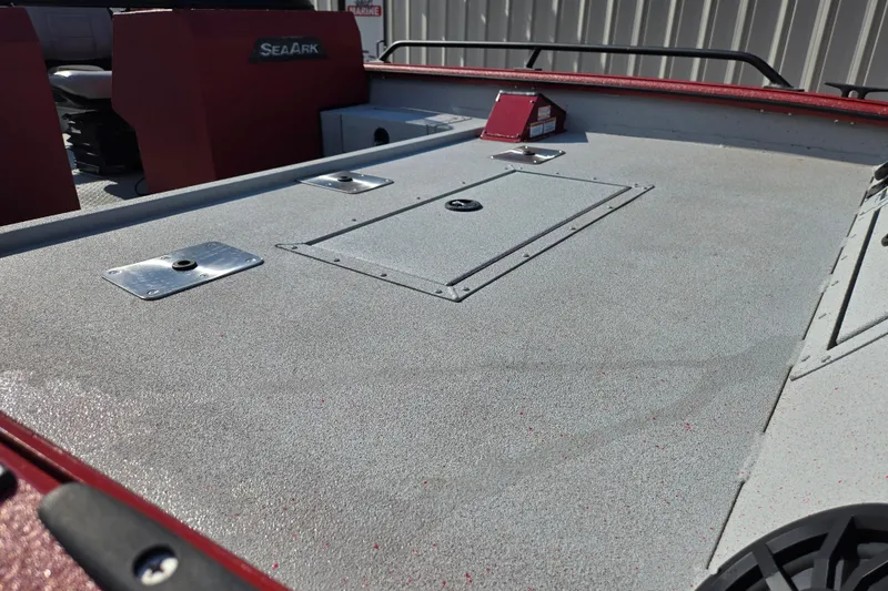 Slide: The Image of 2023 SeaArk ProCat 240 boat deck with storage compartments and red accents. - 10